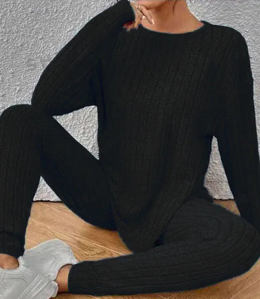 Black sunken stripe two-piece casual homewear set with top and pants on a hanger.