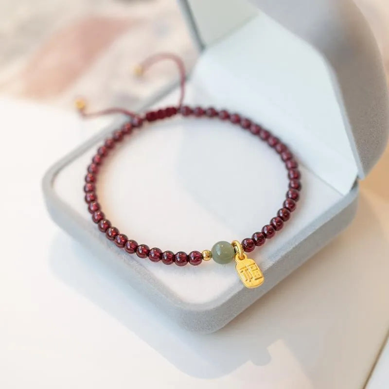 Hand-woven red rope bracelet with strawberry quartz crystals in national tide style