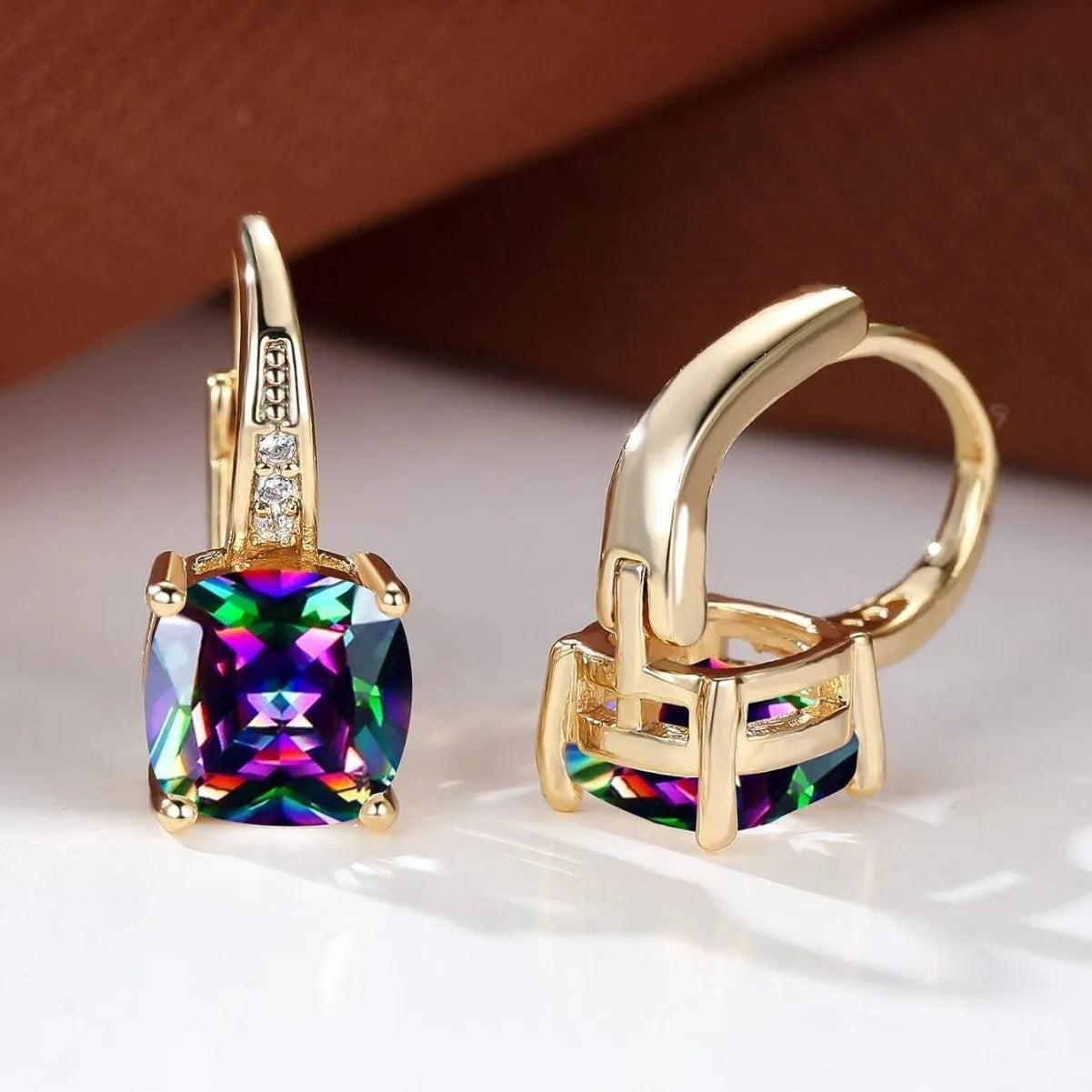 Square geometric ear clip with colourful moissanite inlay on an electroplated copper base.