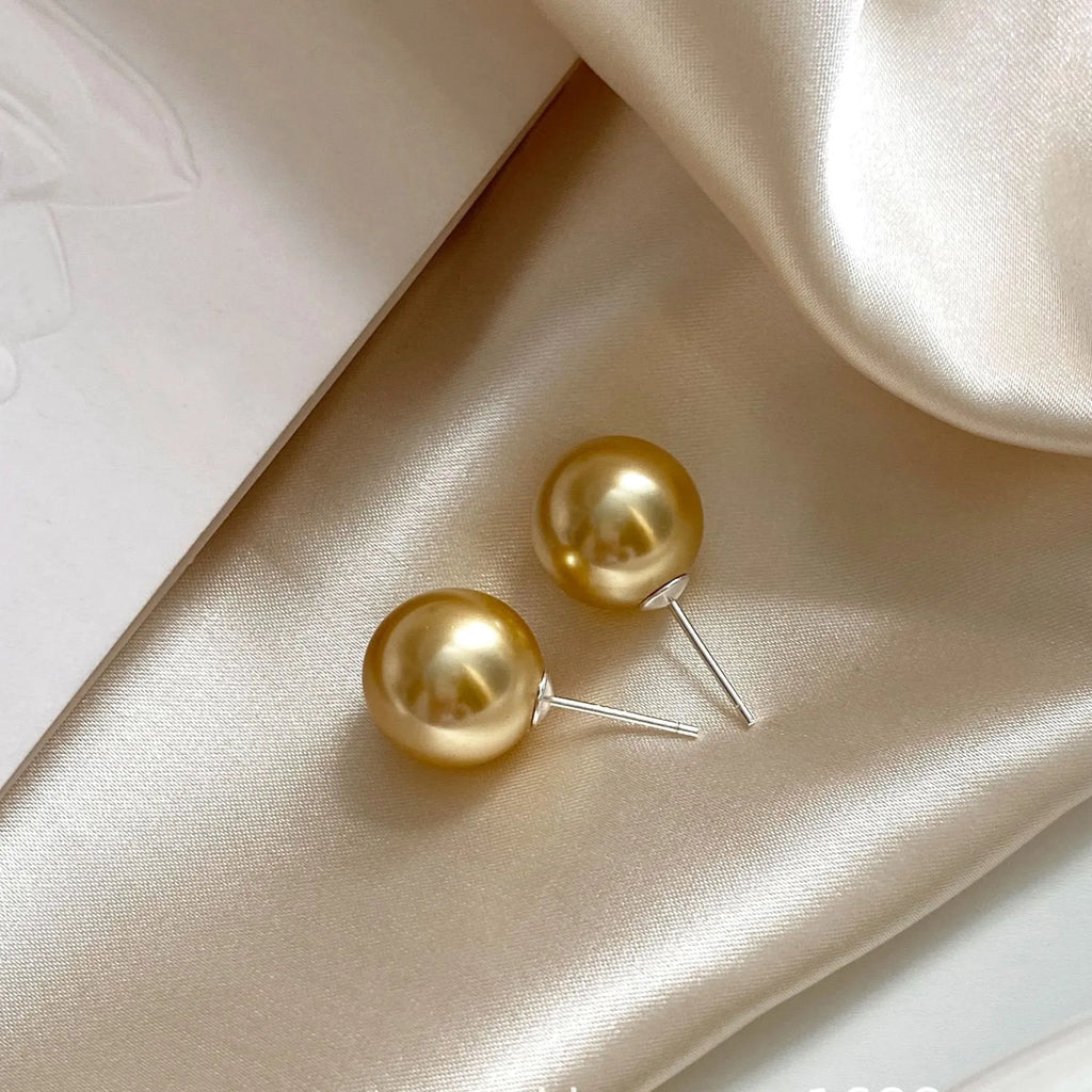 Geometric pearl stud earrings with retro styling in silver with eight-point star details