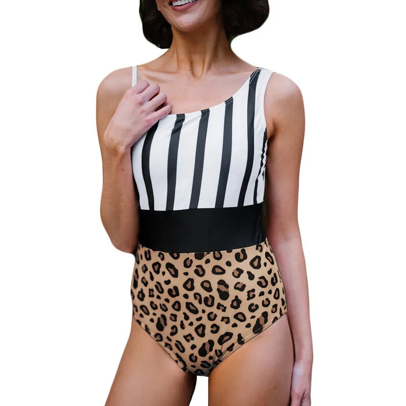Women's leopard print one-piece swimsuit with asymmetric collar and high-waist briefs on a mannequin.