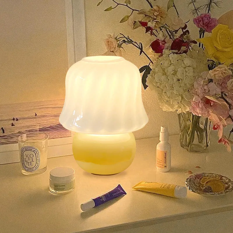 Handmade glazed glass mushroom lamp in cream yellow with push button switch on bedside table