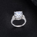 Heart-shaped diamond ring on white background, 925 silver band, open inlay setting
