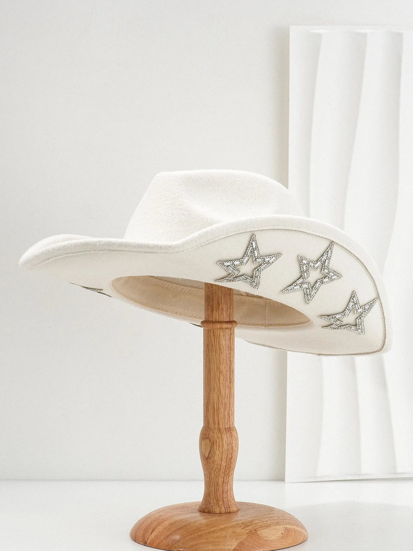 Beige polyester western denim top hat with a conical crown and a silver hexagonal star decoration on the front.