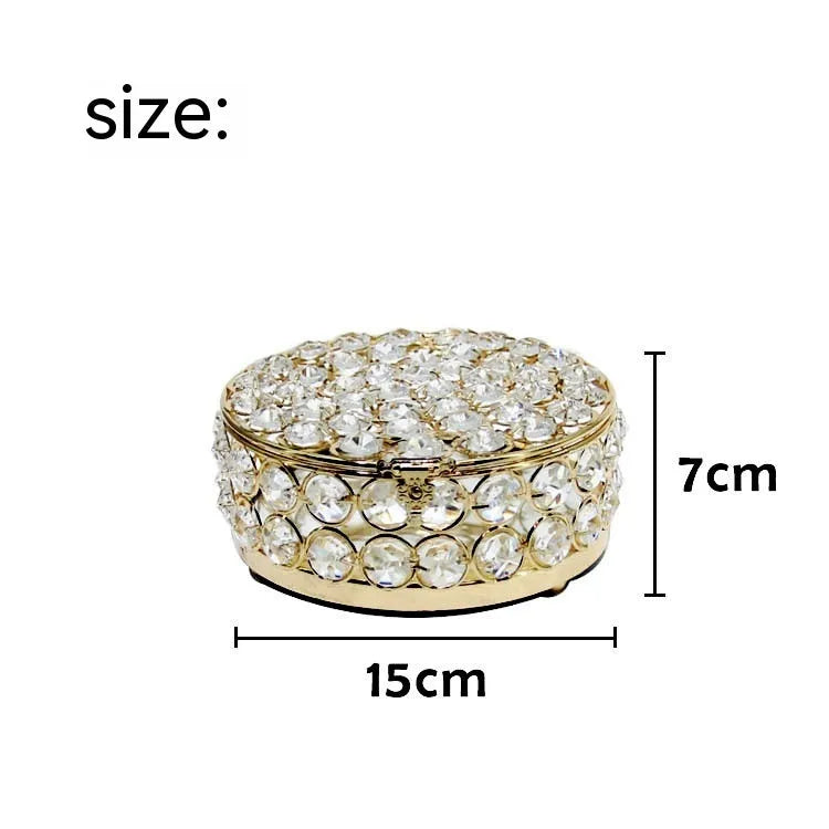 French gold iron frame crystal glass jewellery box with a metal lock closed.