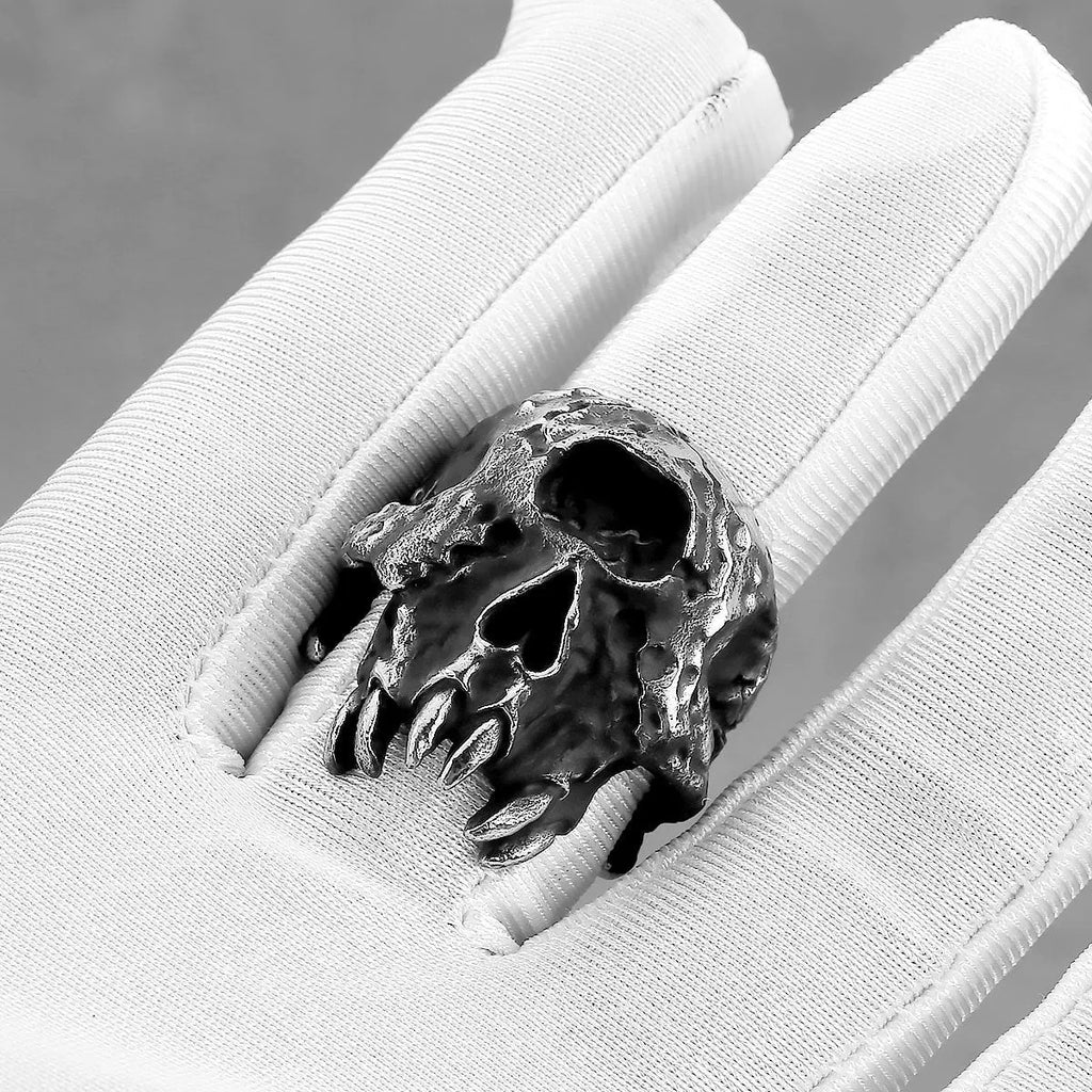 Alloy one-eyed skull ring in retro punk style on a black background.