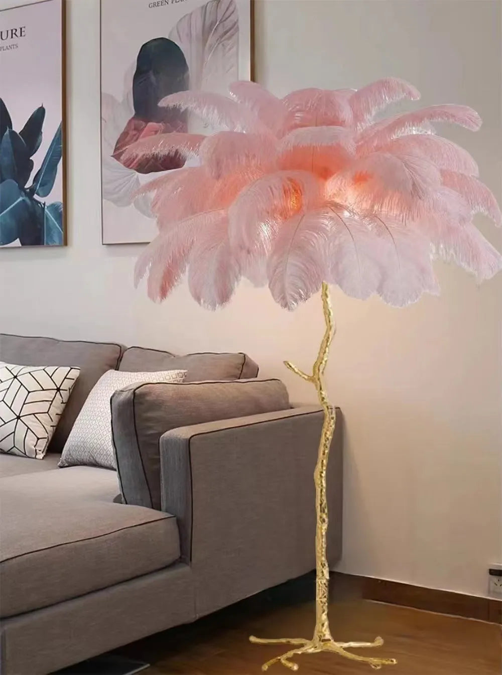 Tall decorative floor lamp with many white resin feathers, standing in a living room corner.