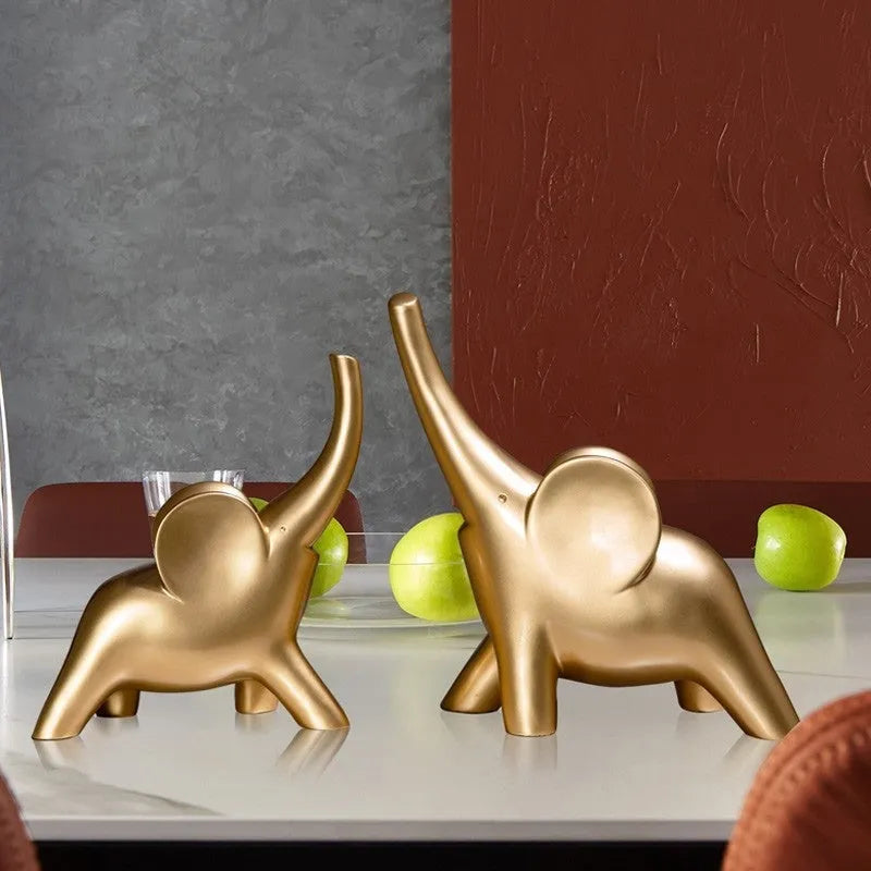 Modern minimalist solid resin elephant ornament in rose gold or white finish on a shelf.