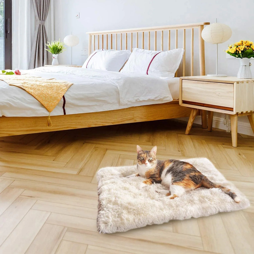 Grey or white pet blanket with long plush hair measuring 61cm by 51cm with non-slip black bottom