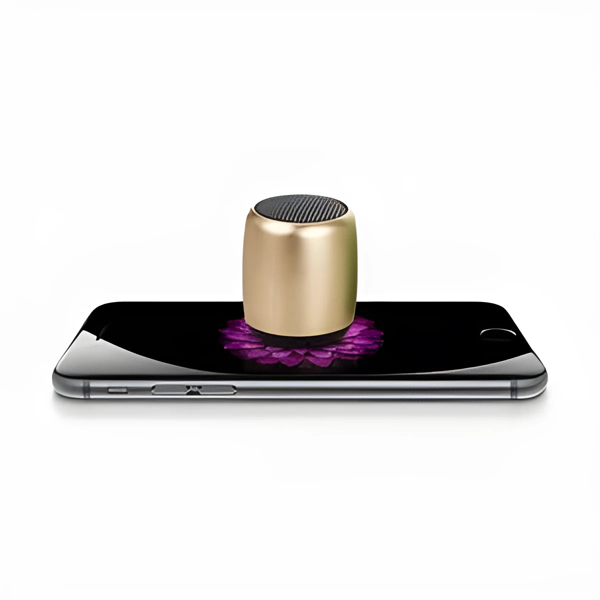 Small portable Bluetooth speaker in black, blue, gold, or pink colour on a table.