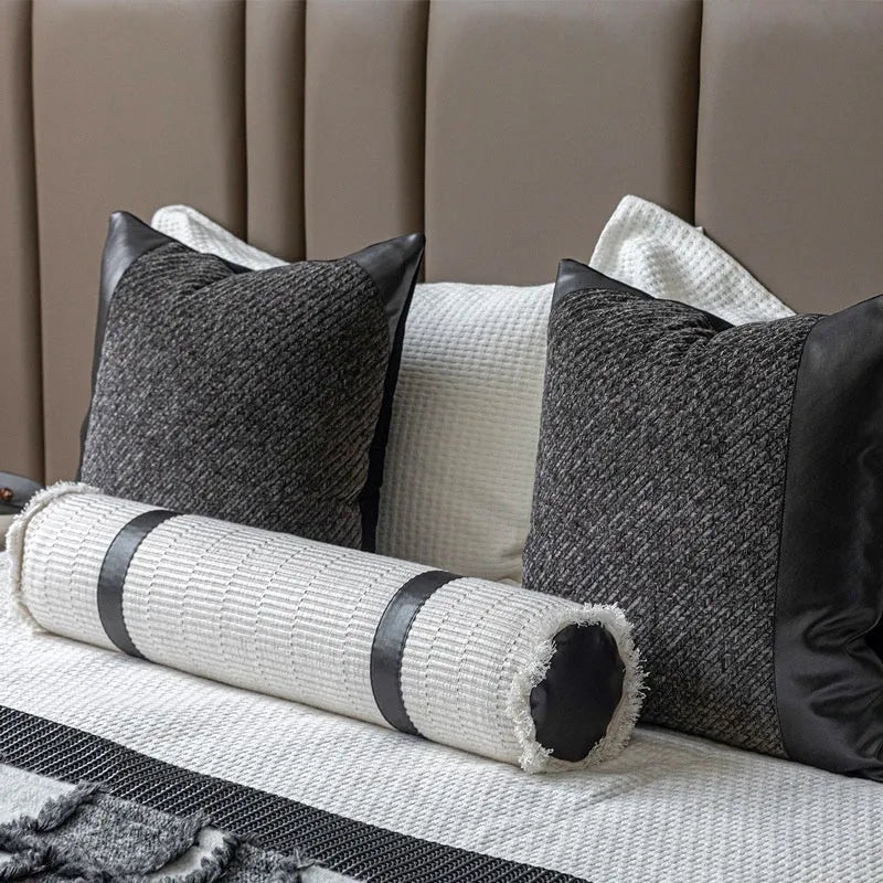 Grey and white plaid bed runner blanket and matching pillow on a double bed.