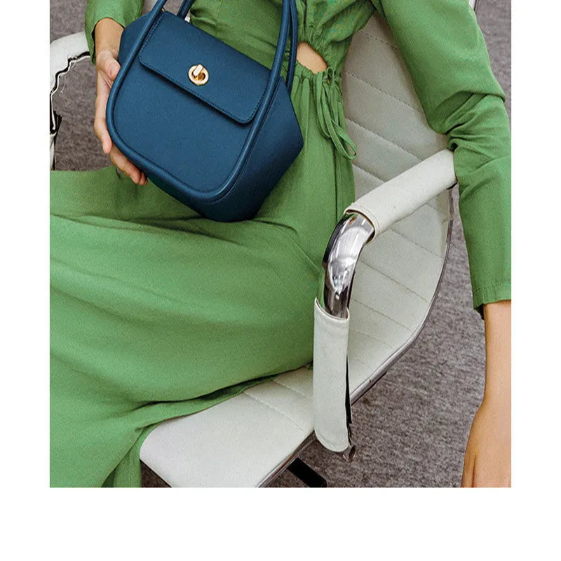 Women's leather wing tote bag with cross-body strap and latch closure in various colour options