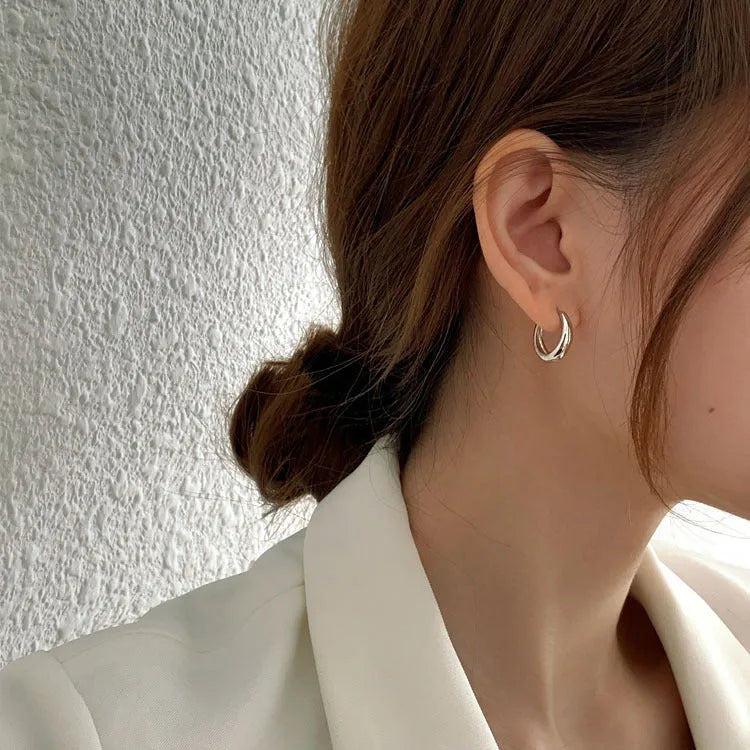 Women's minimalist water drop earrings in gold or silver with geometric round shape
