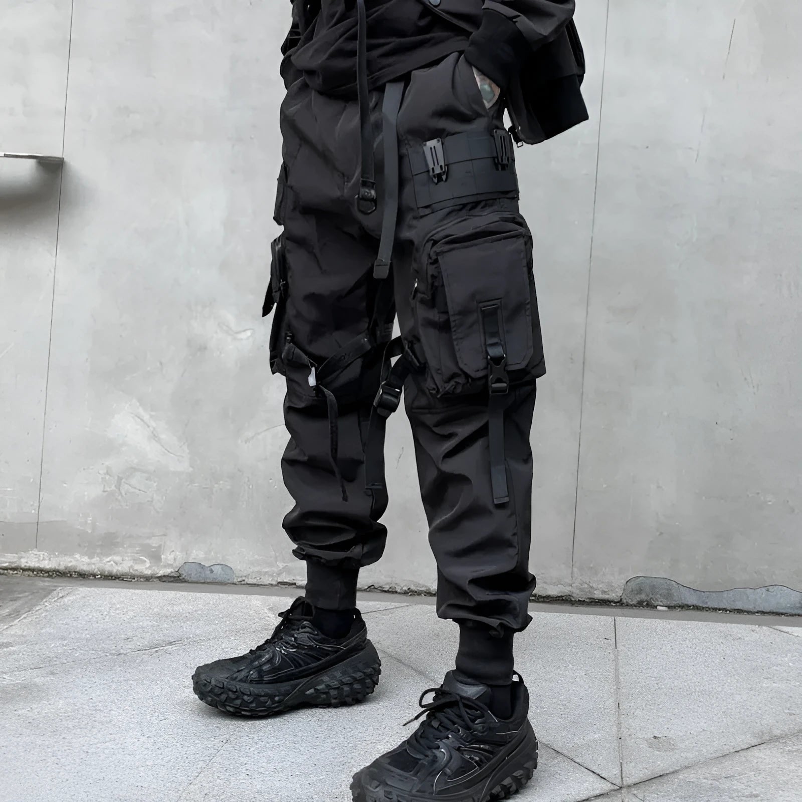 Men's black casual overalls loose fit binding hem trousers front view on mannequin