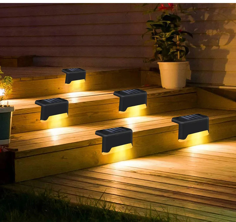 Black solar stair light with ABS housing on outdoor steps, 75x44x42mm IP55 rated