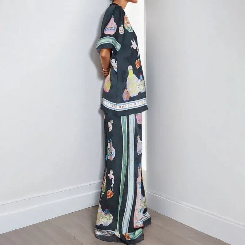 Black women's casual set with cartoon print, featuring a long-sleeve cardigan and trousers.
