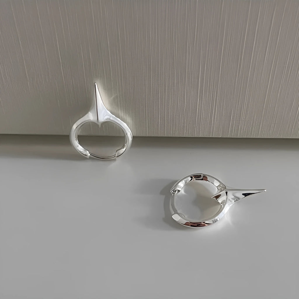 Gold electroplated copper star-shaped ear clips for women, showing geometric design.