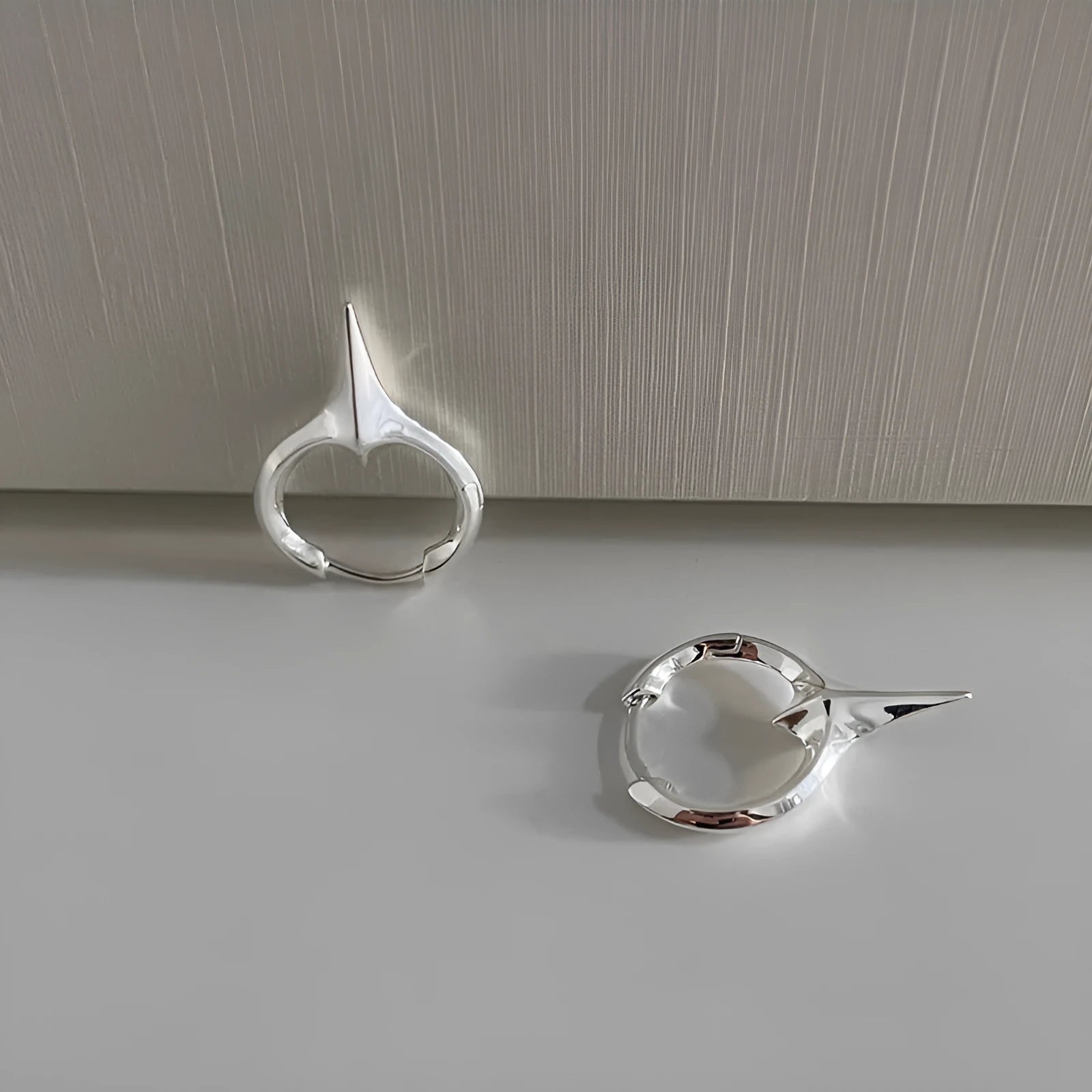 Gold electroplated copper star-shaped ear clips for women, showing geometric design.