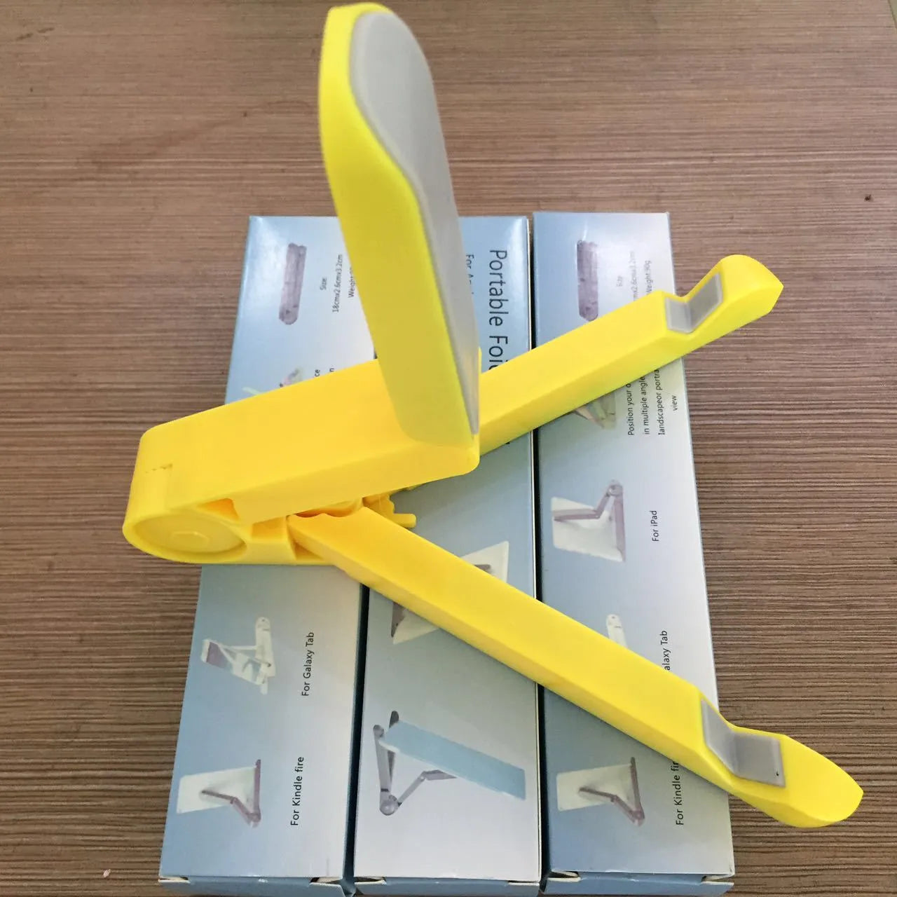 Black foldable tablet holder stand supporting a smartphone in landscape mode on a desk.