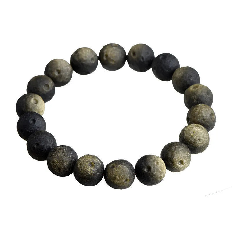 Obsidian crater ball bracelet with textured meteorite-like beads on elasticated cord