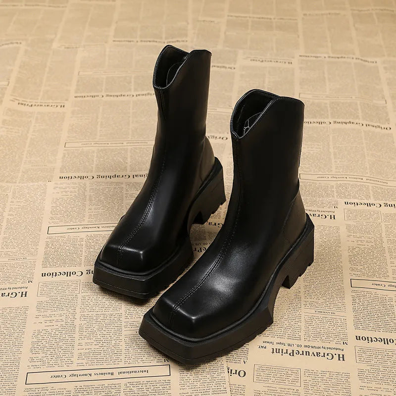 Black platform Martin boots for women with square toe and back zipper on a white background.