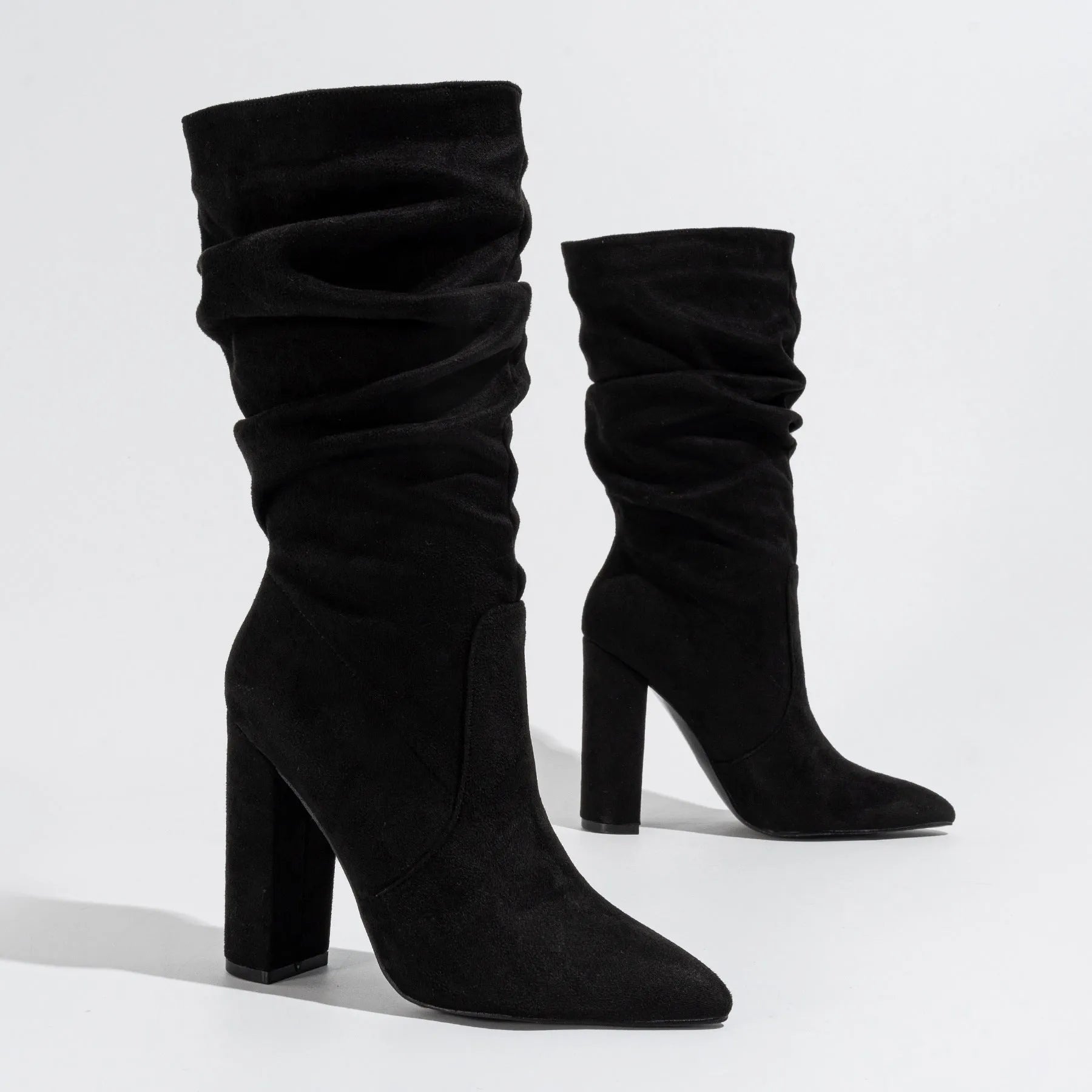 Women's black chunky heel pointed-toe suede boots with mid-calf length and oversleeve design