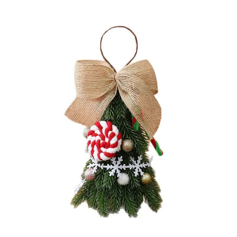 Mini Christmas tree ornament in red and white snowflake design on a tree branch