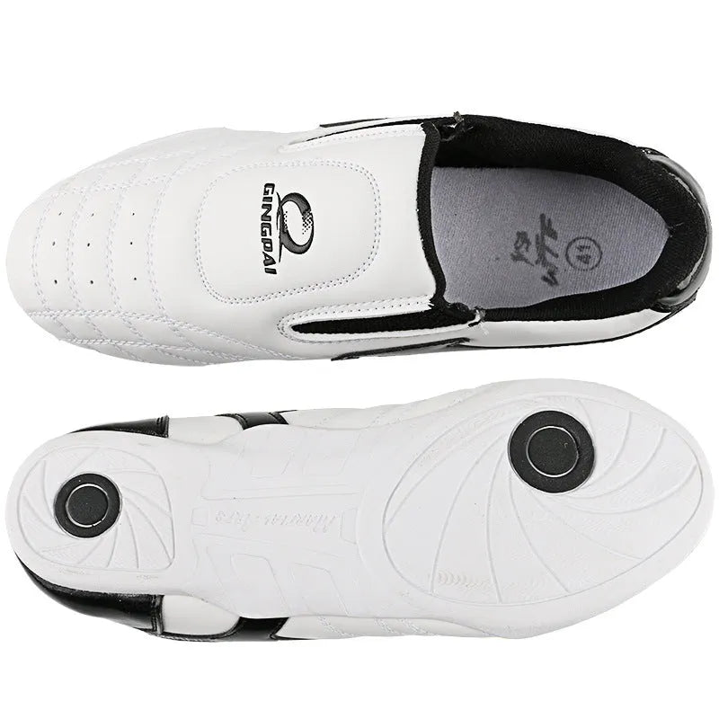 Black and white children's Sanda martial arts training shoes with a soft sole, shown with a shoe bag and socks.