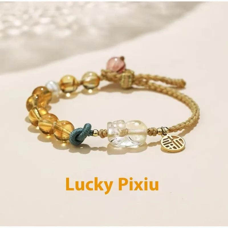 Hand-woven citrine crystal bracelet with zodiac animal design on wrist