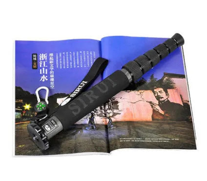 Black carbon fibre SLR camera monopod extended to maximum height with six visible sections