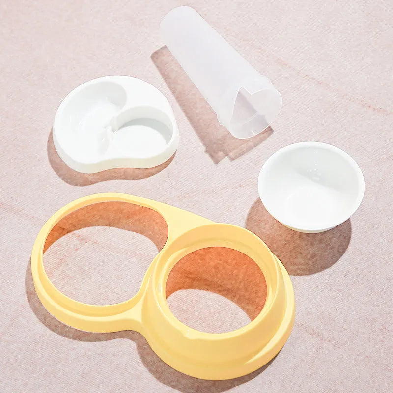 Grey and yellow dual pet feeding bowl with raised neck support and separate food and water compartments.