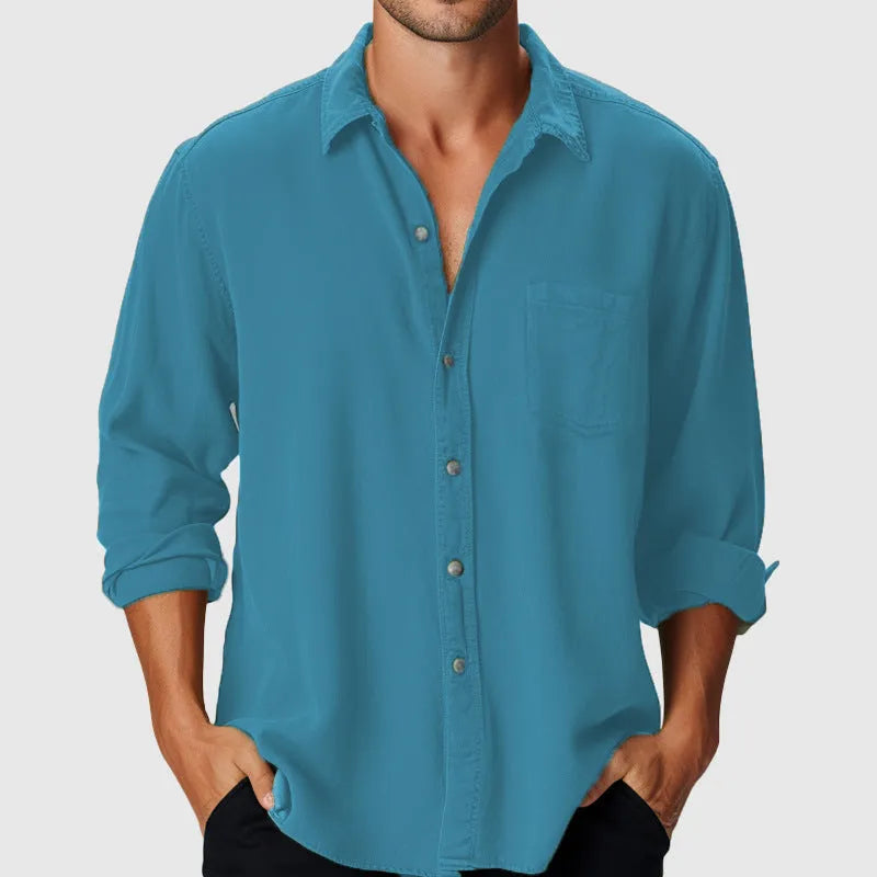 A man's loose-fitting long sleeve beach shirt with a stand collar, shown in a solid colour.