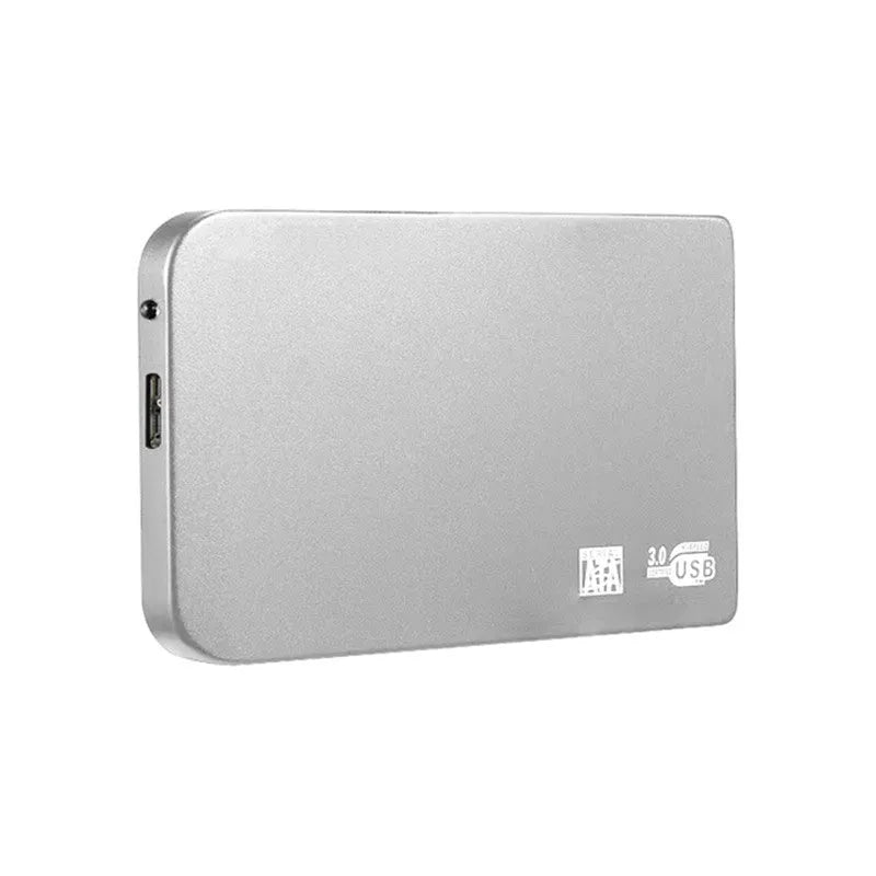 Silver metal USB 3.0 solid-state mobile hard drive with data cable on a desk.