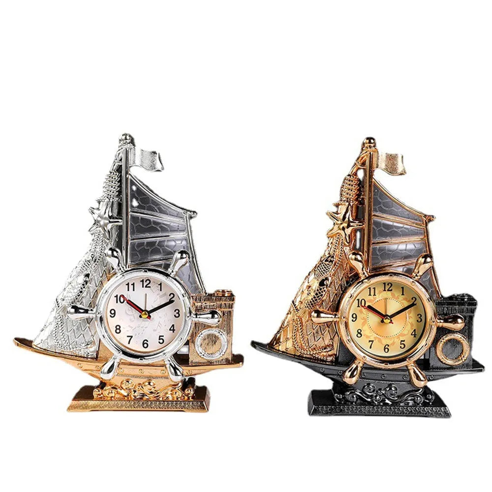 Modern metallic-finish bedroom alarm clock in gold or silver on a bedside table.