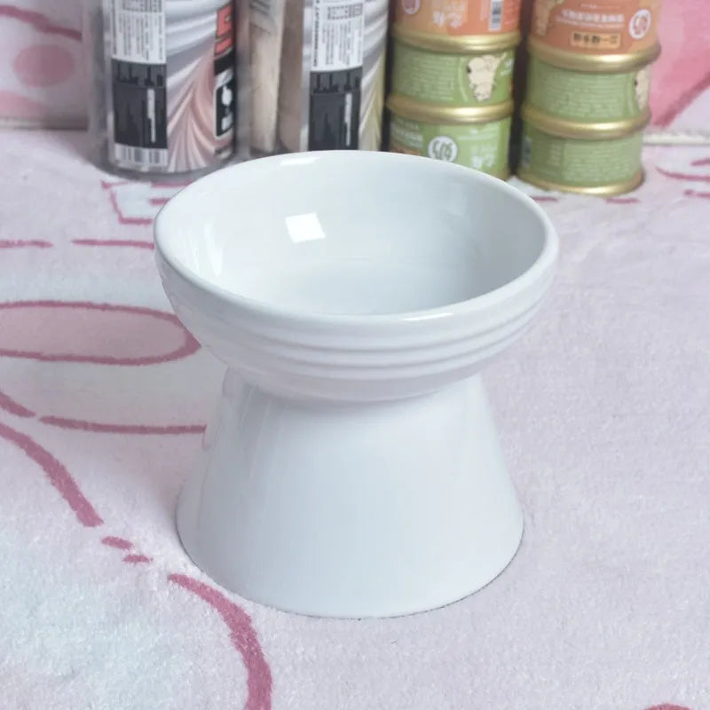 Black chin-high foot ceramic pet bowl for dogs and cats on a flat surface.