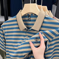 Man modelling a red striped short sleeve casual shirt with mosaic pattern detail.