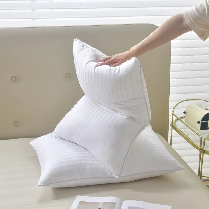 White cotton satin stripe feather pillow showing natural filling and simple styling