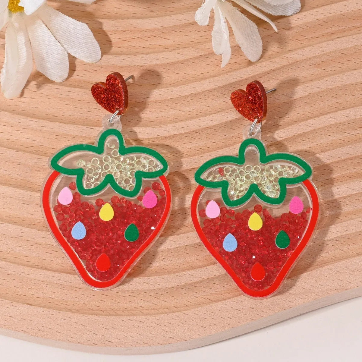 Colourful acrylic earrings with fruit and dessert designs including cherry, strawberry and watermelon shapes