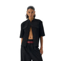 Black handmade loose fit half sleeve hunting shirt with a traditional shirt collar on a hanger.
