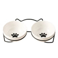 White ceramic pet bowl with cat footprints design in a black iron frame.