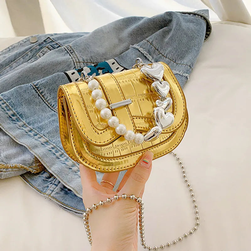 Silver laser pearl women's mini crossbody bag with a horizontal square shape and single shoulder strap.