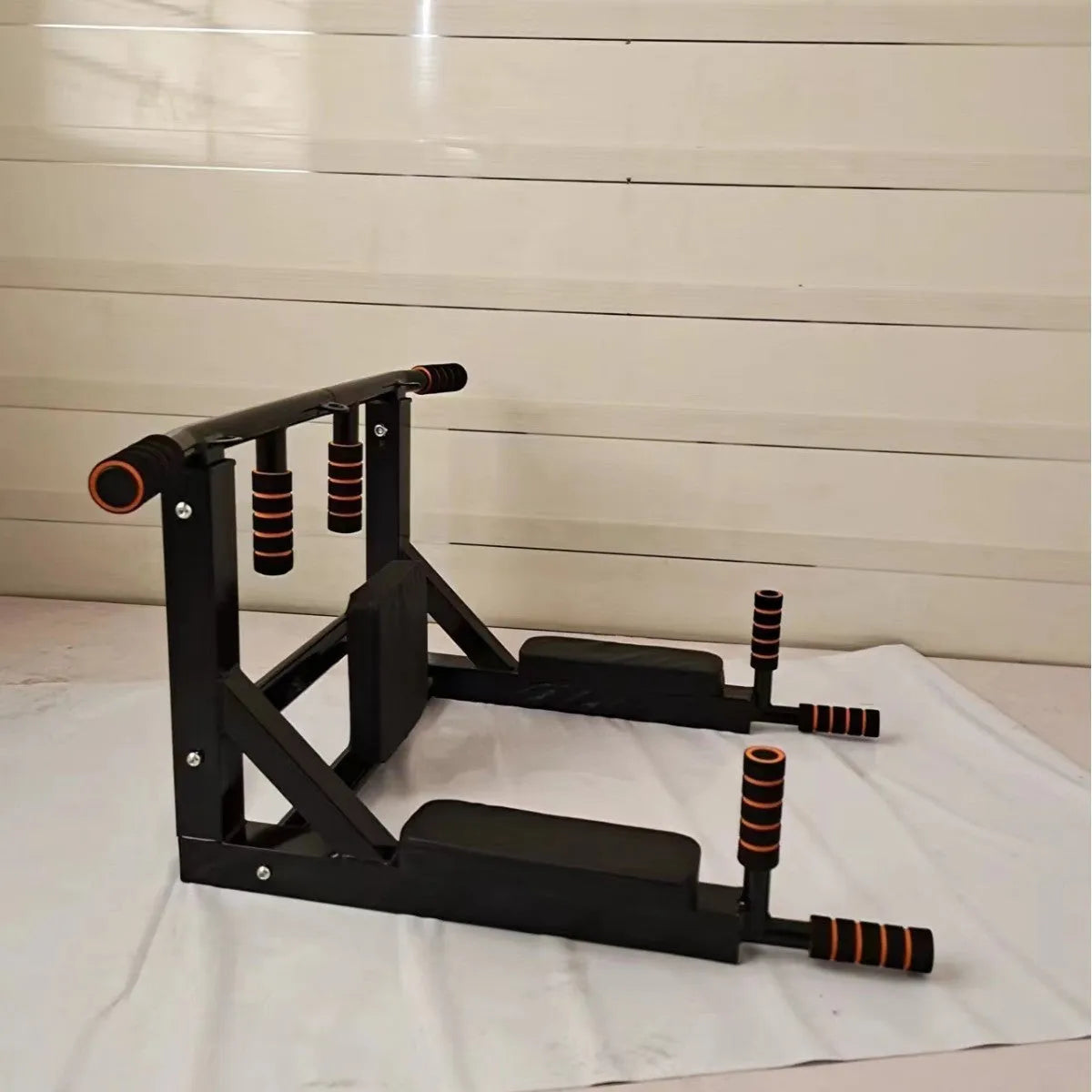 Black wall-mounted fitness rack with sandbag storage and single parallel pull-up bars