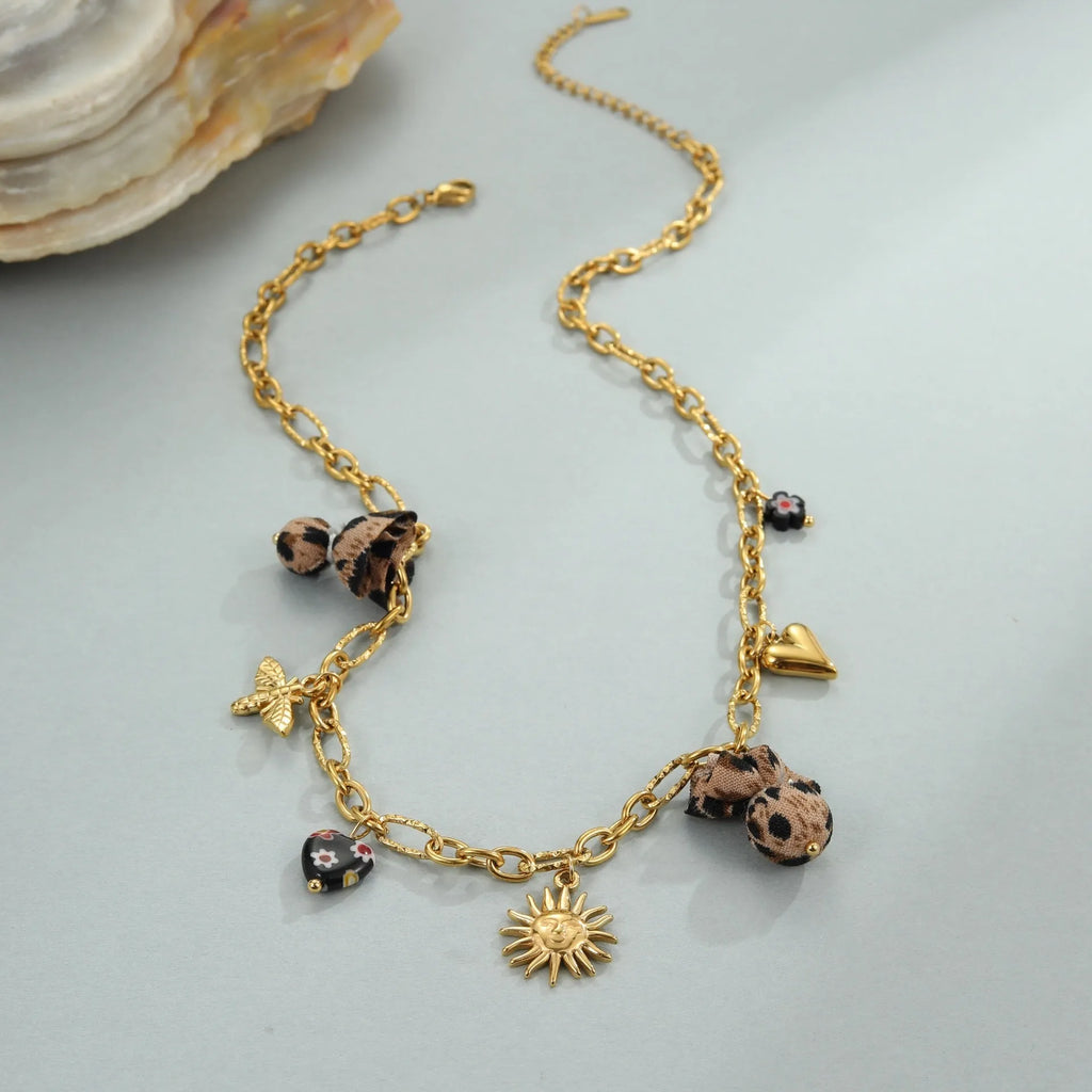 Gold plated stainless steel necklace with geometric leopard, love heart, and flowers pendant on a regular chain.