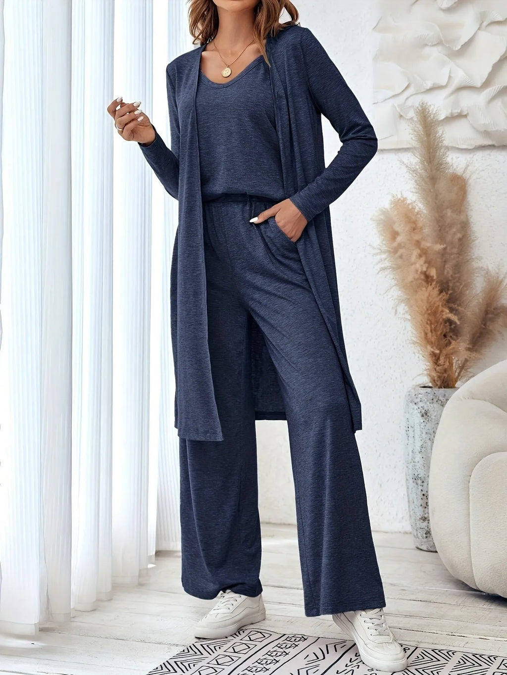 Blue women's three-piece casual suit with sling top, cardigan, and trousers