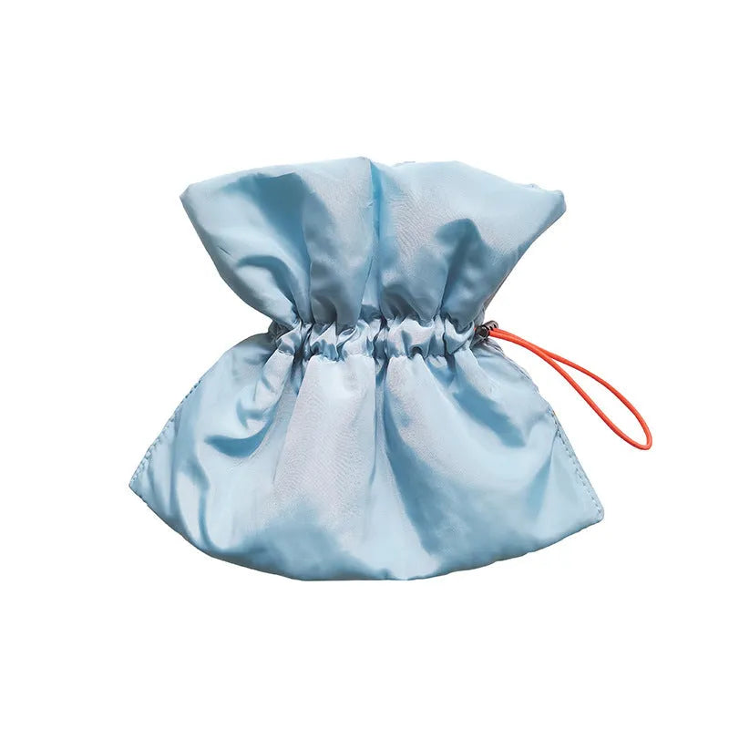 Soft blue adjustable cat recovery collar with elastic buckle on a flat surface