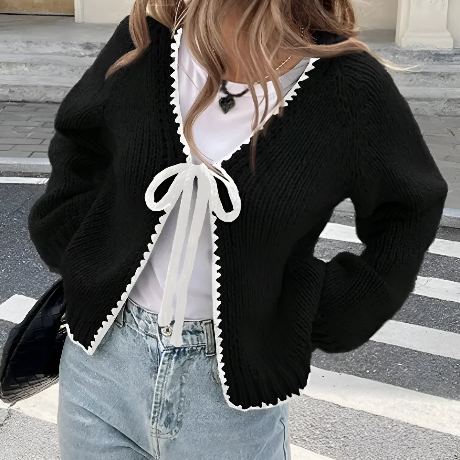 Gray lace-up front cardigan sweater with white crochet flower details and loose long sleeves.