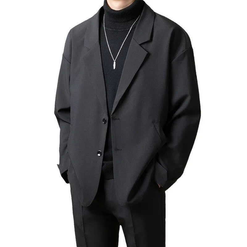 Men's loose fit light business style suit jacket in a polyester blend fabric, shown on a hanger.