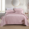 Pure cotton double-sided bed cover three-piece set in a plain colour laid on a bed.