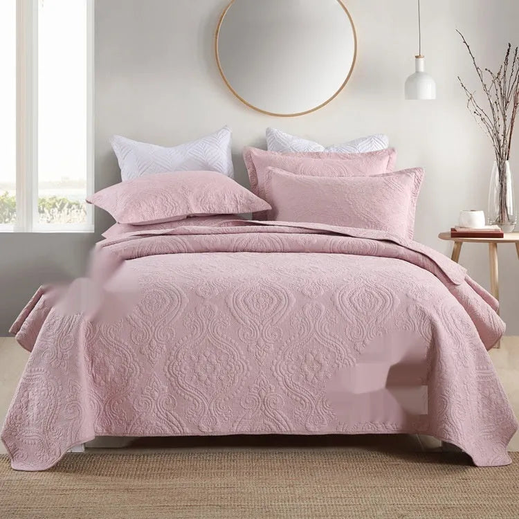 Pure cotton double-sided bed cover three-piece set in a plain colour laid on a bed.