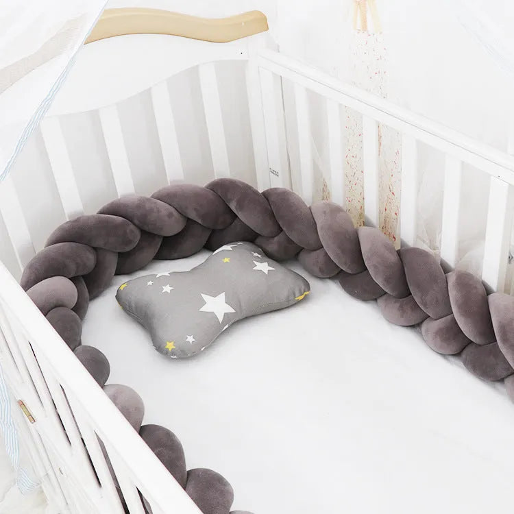 Multi-colour baby crib bumper made of spandex velvet, shown bent around a crib edge.